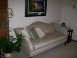Century camelback sofa with Terry Redlin signed print hanging overhead
