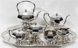 Lot#1003, BLACK, STARR, & FROST STERLING SILVER TEA & COFFEE SERVICE WITH TRAY, SEVEN PIECES,,,The sterling silver service is monogrammed and includes 1 teapot, H.6" to the handle, 1 coffee pot, H.7 7/8" to the handle, 1 hot water kettle on stand with sterling burner, H.12 1/2" to the handle, 1 creamer, 1 covered sugar bowl with gold wash interior,1 waste bowl, and 1 tray, L.27"; all are stamped "Black, Starr & Frost/Sterling" with trademark and number 1316 (see photo), except the tray which is stamped 1150. Totaling approximately 272.8 troy oz.