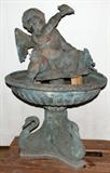 LOT#16  BRONZE CHERUB FOUNTAIN, 48" H. X 30" DIA, depicts a cherub holding a nautilus shell in his right hand with a frog on his knee and holding down a turtle in his left hand; sitting in a shell form bowl, all on a pedestal supported by three swans forming a base. Includes an electric pump.