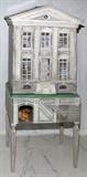 LOT#87  ERIC LANDSDOWN PAINTED WOOD DOLL HOUSE, SAN FRANCISCO, 1988, H 53", W 22", D 15", classical style house with leaded etched glass skylight. Front of house has white framed windows and hinged door with front being hinged and when opened exposes all the rooms and miniature furniture and teddy bears. Base has a cubicle with a dog figure all supported on four tapered square legs. Painted on all sides. Signed lower front foundation Eric Landsdown 1988 San Francisco.