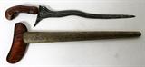 LOT#195  TRADITIONAL INDONESIAN KRIS KNIFE, 19TH C, L 12" BLADE, having a 12" wavy meteor iron blade with hard wood hilt possibly mahogany hilt, decorated brass clad wood sheath with hardwood throat.