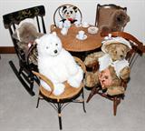 LOT#230  STEIFF, CHARLEEN , KINSER, AVARTI, ETC. STUFFED TEDDY BEARS, TABLE AND CHAIRS, C1980-90, 27 PCS., includes one Steiff (replica 1938) stuffed panda, three brown bears including one Savannah, one polar bear all measure between 14" - 28" L. all seated around a child size wicker round table with bent metal pedestal and legs, 20" Dia. X 19" H. two wicker and bent metal chairs,23" H., one cane back rocker, 24" H., one spindle back arm chair, 23" H. and one Hitchcock style black lacquer rocker, 26" H; also a miniature porcelain tea set, with cups saucers, creamer and covered sugar. Lace doily and two checkered table linens. 27 pieces total, including bears.