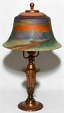 LOT#1020  PAIRPOINT REVERSE PAINTED GLASS BOUDOIR LAMP, EARLY 20TH C., H 15", DIA 8 1/2", Bell-form shade painted at the interior with a landscape, signed "The Pairpoint Company" at the rim, raised on a patinated metal base marked "Pairpoint, D 3040, Made in USA" and P enclosed in a diamond.