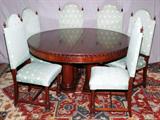 LOT#1031  MAHOGANY ROUND DINING TABLE, DIA 60", WITH 6 DINING CHAIRS & 4 BOARDS, Circa 1900. pedestal base. Four leaves. Dia of table is 5'. H 32". Six chairs with tight upholstered seats and backs. Upholstered in celadon green fabric.