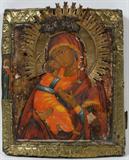 LOT#1029  RUSSIAN ICON OF THE VLADIMIR MOTHER OF GOD, C. 1780, 12" X 10", Circa 1780. Antique primitive icon having brass rim and halo.