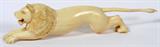 LOT#1057  CHINESE CARVED IVORY LION, L 11 3/4", Depicting a crouching male lion.