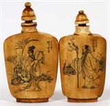LOT#1059  CHINESE CARVED IVORY SNUFF BOTTLES, PAIR, H 2 1/2" AND 2 1/4", One features the figure of a woman, the other a man and each with a poem on the back.