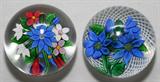 LOT#1184  ST. LOUIS GLASS PAPERWEIGHTS, TWO, DIA 3", Including 1 with blue flowers on a white latticino ground, and 1 with a bouquet of colorful flowers; both are signed and dated 1982 and 1981, respectively.