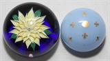 LOT#1188  BACCARAT CRYSTAL PAPERWEIGHTS, TWO, DIA 2 1/2" & 3", Including 1 opaline glass paperweight with fired gold fleur de lis motifs, and 1 with a yellow flower on cobalt, dated 1972; both with acid etched stamp.