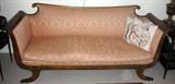 LOT#1232  EMPIRE STYLE MAHOGANY SOFA, SATINWOOD INLAY, L 77", Coral color upholstery. Loose seat cushion. Quality frame with satinwood inlays, splay legs with brass claw caps. Circa 1940.