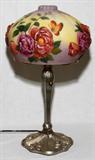 LOT#1450  PUFFY STYLE GLASS & PATINATED  METAL TABLE LAMP, H 22", DIA 10", The puffy style shade with pink rose motif, raised on an art nouveau style base.