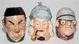 LOT#1411  AUSTRIAN PORCELAIN TOBACCO JARS, C. 1880, THREE, H 5 1/2" - 7 1/2", Including 1 man smoking a pipe, 1 of a driver, and 1other figure.