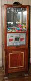 LOT#2050  MILLS CLAW MACHINE, H 72", W 21", Wood case with nickel plaque and coin insert, 5-cents to operate.  Patent date 1933.  Replaced prizes.