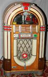 LOT#2054  WURLITZER MODEL 1015 JUKEBOX H 60", W 31", Takes nickel, dimes, and quarters for the 24 selections of 78rpm records; red and white plastic panels illuminate. Similar to the "Bubble" Juke Box from "Happy Days". Provenance: Mike Gorski.