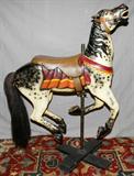 LOT#2057  HERSCHELL SPILLMAN CARVED WOOD CAROUSEL HORSE, H 54", In a running position, with saddle, horsehair tail and metal horseshoes.  Retains some original paint.  Provenance:  A carousel in Detroit, outside of Belle Isle.
