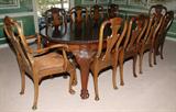 LOT#2092  IRISH MAHOGANY OVAL DINING TABLE & TEN CHAIRS, The table (H 32", W ca. 45", L 60" closed, L ca. 103" extended with leaves) has two wide leaves, each 23" wide, on heavily carved cabriole legs with paw feet.  Together with a set of dining chairs having heavily carved splats above horseshoe seats with inset leather and including 2 uniquely carved armchairs and 8 side chairs.  Chippendale style.