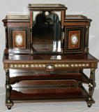 LOT#2192  BRONZE AND SEVRES MOUNTED AMBOYNA AND EBONIZED SIDE CABINET, C. 1860, 0, L 59", D 53", Upper section with a projecting center section enclosing a mirrored back flanked by cupboard doors inset with porcelain portrait medallions further flanked by gilt-incised columns; the lower section with a rectangular top above three frieze drawers fitted with foliate painted porcelain plaques,  gilt incised and ebonized turned columns joined by a two-tier shelf stretcher with a mirrored back.