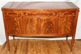 LOT#2277  HEPPLEWHITE STYLE MAHOGANY BOW FRONT SIDEBOARD, CIRCA 1940'S, H 37", L 54", D 23", Featuring a wide center drawer flanked by two drawers all above four doors.  The center doors open to reveal two sliding drawers.  Overall satinwood circular and string inlay.
