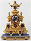 LOT#2320  FRENCH GILT BRONZE & PORCELAIN MANTEL CLOCK, H 15", W 10", Acorn finials on the sides.  Urn finial on top.  Beaded swags. Gilt metal bezel opens to a cobalt blue enamel face with Roman numerals set in white porcelain, gilt hands with floral and gilt enamel accents between the hours; cobalt blue medallions with gilt and colored enamel adorn the lower front of the case; mounted on a light blue velvet and gilt footed base;  two key wind;