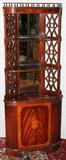 LOT#2366  MAHOGANY CORNER CABINET, H 65", W 26", Three open shelves with mirrored back and flanked by pierced panels, a single cabinet door at the base.  Mid 20th century.  26" Wide.