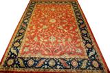 Lot# 42 INDO-SERAPI, WOOL RUG, EARLY 20TH C, 12' X 18', having an orange ground, small flower medallion surrounded by flowers and vines throughout, with one large navy blue border with geometric floral designs flanked by two smaller borders and one orange border along the outer edge.