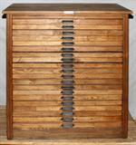 Lot# 60 HAMILTON MFG. CO. OAK TWENTY DRAWER PRINTER'S CABINET, H 43", L 39", D 21", Printer's cabinet, manufactured by Hamilton Mfg. Co., Two Rivers, WI. Each drawer has an iron pull marked "Hamilton" and includes antique printer's blocks.