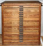 Lot# 61 HAMILTON MFG. CO. OAK EIGHTEEN DRAWER PRINTER'S CABINET, H 43", L 38", D 22", Printer's cabinet, manufactured by Hamilton Mfg. Co., Two Rivers, WI. Each drawer has an iron pull marked "Hamilton" and includes antique printer's blocks.
