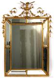 Lot# 63 GILT WOOD WALL MIRROR, H 52", W 42", having a vase, floral, vine and leaf designs at the crest; narrow mirror panes around the periphery framed in carved gilt wood surround a large central rectangular mirror; all in bevel glass.