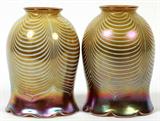 Lot# 97 ART GLASS TULIP FORM GLOBES, PAIR, H 6", DIA 4", both of iridescent amber glass with swirl form white accents in the form of tulips.