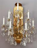 Lot# 125 CRYSTAL AND BRASS 7-LIGHT SCONCE, H 24", W 20", having gilt brass arms, adorned with faceted crystal prisms all mounted to a gilt brass mounting plate;