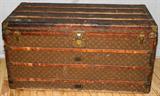 Lot# 141 LOUIS VUITTON STEAMER TRUNK, H 23", L 43", D 22", Having a full compliment of five fitted and removable storage compartments. Signed brass hardware and applied tag for the interior. Serial number 148085 and monogrammed DMM on one end of the exterior..