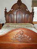 Lot# 144 MAHOGANY ANTIQUE AMERICAN HEADBOARD & FOOTBOARD, W 68", L 82", having a high arched carved crest at the headboard with finials at the posts, with distinct burl wood patterns; carved scrolling leaf designs on the footboard with burl wood throughout. H 82", L 68" W.