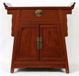 Lot# 155 ASIAN WOOD CABINET, H 30", L 29", D 14", The top is altar table form with a central full-length drawer above two doors which reveal a single shelf. Splayed frame shape with trapezoidal shape doors and upper drawer façade and angled legs.