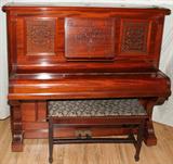 Lot# 173 VOSE AND SONS (BOSTON), UPRIGHT "CABINET GRAND" PIANO, CARVED MAHOGANY, H 57", W 28", L 63", upright design; pierced upper panel and carved music rack; Vose and Sons brass plate on string board; #20622. early 20th c; includes a bench with seat cushion.