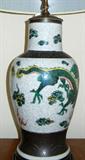 Lot# 207 PORCELAIN HAND PAINTED URN FORM VASE LAMP, H 36", W 9", Dragon & Lily pad design with etched metal accents at base and top of urn lamp. Oriental metal finial.