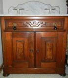 Lot# 234 ANTIQUE AMERICAN MAHOGANY WASH STAND, H 38", L 31 1/2", D 16", Two lower doors, one upper door. White marble with grey veining. Two pedestal mounted stands against back support.