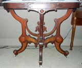 Lot# 235 AMERICAN EASTLAKE, MAHOGANY & MARBLE TOP TABLE, H 30", L 35", D 21", Rectangular shape, carved stretcher beneath with burl scrolling, carved & circular designs. On porcelain casters. White & grey veined marble.