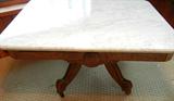 Lot# 239 ANTIQUE AMERICAN MAHOGANY COFFEE TABLE, H 17", L 32", White marble top with grey veining. Burlwood inlay. On casters.