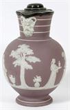 Lot# 252 WEDGWOOD LILAC JASPERWARE & SILVERPLATE EWER, H 8", having a silver plate hinged lid, rim and spout, lavender and white, 'Sacrifice' scene with classical Greek ram-horned Jupiter Ammon under spout. Wedgwood marks on the underside.