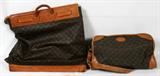 Lot# 318 LOUIS VUITTON VINTAGE SHOULDER BAG AND PORTFOLIO BAG, 2 PCS., two bags with the signature monogram coated canvas and includes one smaller duffel bag with shoulder strap and cloth interior pockets, 8" H. x 20" L. x 12" W. second item is a portfolio bag with wrap over leather top with retention straps and brass ring at the center to accommodate a lock. Both exhibit Vuitton marks; duffel has monogram.