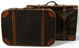 Lot# 320 LOUIS VUITTON MONOGRAM SOFT SIDED CANVAS LUGGAGE, 2 PCS., H 22", W 32", D 12", two different size pieces of luggage having the signature monogram coated canvas sides with leather top and bottom panels on the leather straps. One measures 22" H. x 32" W. x 12" D; second piece measures 21" H. x 30" W. x 9" D. The larger suitcase has zippered side panel access. The smaller suitcase has a zippered lid.