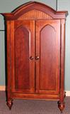 Lot# 344 ROMWEBER GOTHIC INFLUENCED ARMOIRE/ENTERTAINMENT CENTER, H 88", W 50", D 26", The two doors open to reveal a single shelf. Label is at the interior of the cabinet.