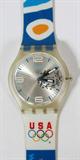Lot# 439 SWATCH, 2004 USA OLYMPIC WATCH AND CLEAR CASE, Red, White and Blue. 'Welcome Home'. Plastic case with Olympic logo sticker;