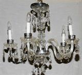 Lot# 452 CRYSTAL FIVE-LIGHT CHANDELIER, H 17", DIA 18, having five scroll form crystal arms with faux candle lights with suspended teardrop shape prisms from each bobeche and metal center shaft surrounded by a crystal center shaft.