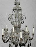Lot# 451 CRYSTAL CHANDELIER 10 ARMS, H 28", DIA 23", CIRCA 1960, Five scroll arms spaced between 5 longer arms. A quality crystal chandelier that needs some restoration. No bobeches to longer arms.