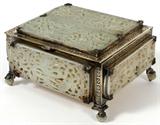 Lot# 1003 EDWARD I. FARMER STERLING & CHINESE JADE MOUNTED BOX, H 4", W 7 1/2", D 6", A sterling silver box set with four jade plaques about the exterior and two plaques at the hinged cover, raised on four jade bead feet, stamped at the underside "Edward I. Farmer/New York" and "Sterling" (see additional photos). Each pierced jade plaque is light celadon in color and is carved with a dragon among foliage or birds, measuring 5 1/2" x 2 1/4", approximately. From the Collection of John P. O'Hara, Bloomfield Hills, Mich.