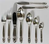 Lot# 1007 GEORG JENSEN 'ACORN' STERLING FLATWARE, 83 PIECES-SERVICE FOR TWELVE, Including 12 place knives, L.9", 12 place forks, L.7 1/4", 12 salad forks, 12 butter spreaders, 21 teaspoons, 5 dessert spoons, 5 demi tasse spoons, 3 table spoons, L.8", and 1 master butter knife, L.7"; each piece is stamped "Georg Jensen" in a beaded oval, "Sterling Denmark". Totaling approximately 91.8 troy oz. weighable. From the Estate of Walter Connolly, Grosse Pointe Farms, Mi.