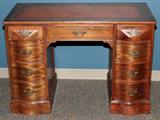 Lot# 1029 MAHOGANY EIGHT-DRAWER KNEE HOLE DESK, H 29", W 42", D 21", Central drawer is flanked by three drawers on the right side and four drawers on the left side. Having a red tooled leather top.