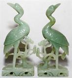 Lot# 1064 CHINESE CARVED JADE FIGURES OF CRANES, PAIR, H 10", Each carved as a standing crane alongside foliage. From the Collection of John P. O'Hara, Bloomfield Hills, Mich.