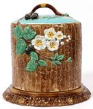 Lot# 1088 HOLDCROFT BLACKBERRY MAJOLICA CHEESE DOME ON A W. JAMES & CO. TRAY, 19TH C., H 11", DIA 11", A Holdcroft majolica Stilton cheese dome, blackberry motif, H.11", Dia.9", on a bark pattern majolica plate by W. James & Company, London, Dia.11 1/2". Measures H.12 1/2" overall.